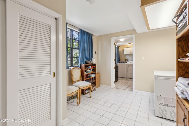 bathroom with washer and clothes dryer, tile patterned floors, and baseboards