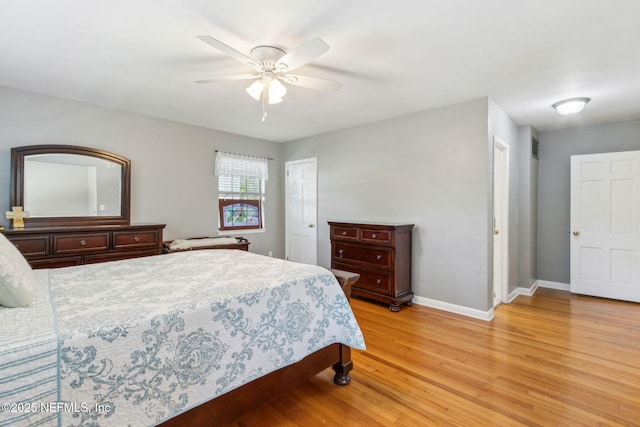 bedroom featuring a closet, baseboards, light wood-style floors, and a ceiling fan