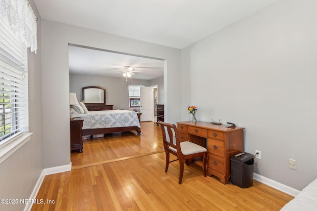 bedroom with light wood-style flooring, baseboards, and ceiling fan