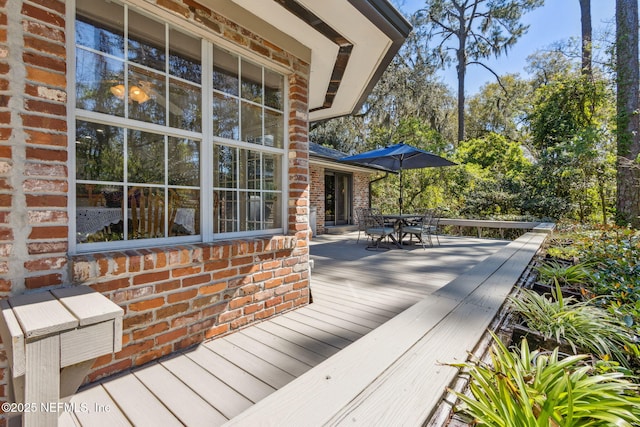 wooden deck featuring outdoor dining area