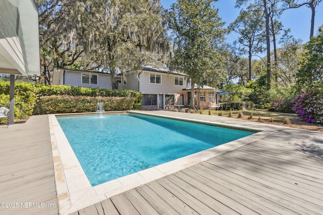 view of swimming pool featuring a wooden deck