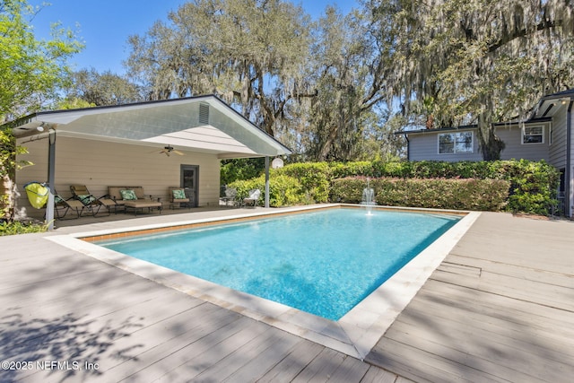 outdoor pool featuring a patio area and a ceiling fan