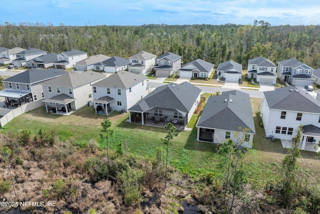 aerial view featuring a residential view and a forest view