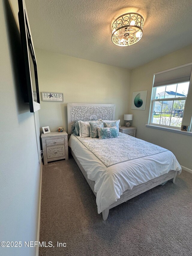 carpeted bedroom with a textured ceiling