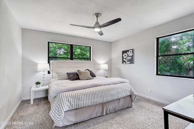 carpeted bedroom featuring ceiling fan and baseboards