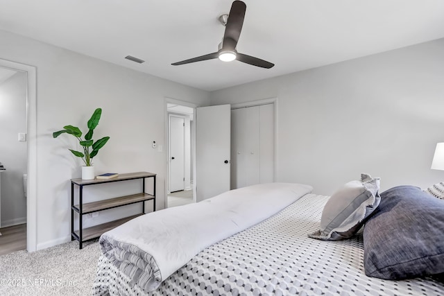 bedroom with light carpet, a ceiling fan, visible vents, baseboards, and a closet