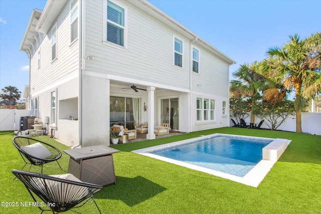 back of house featuring a fenced in pool, a yard, an outdoor hangout area, a ceiling fan, and a fenced backyard