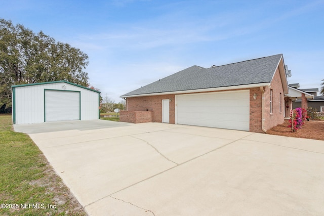 view of side of property featuring a garage, brick siding, and a shingled roof