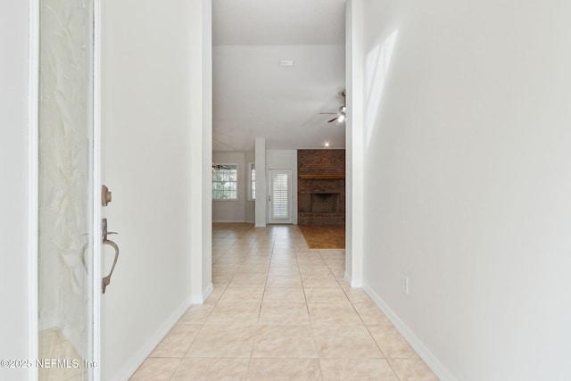 hall with light tile patterned floors and baseboards