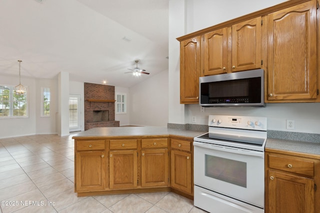 kitchen featuring a fireplace, white electric range, stainless steel microwave, a peninsula, and ceiling fan with notable chandelier