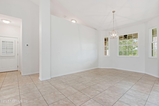 unfurnished room featuring light tile patterned floors, baseboards, and a chandelier