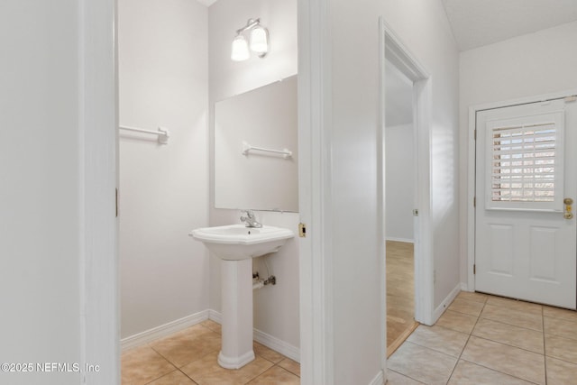 bathroom with tile patterned flooring and baseboards