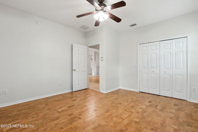 unfurnished bedroom with baseboards, visible vents, and a closet