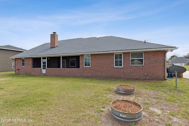 rear view of house featuring brick siding, a lawn, a chimney, and a shingled roof