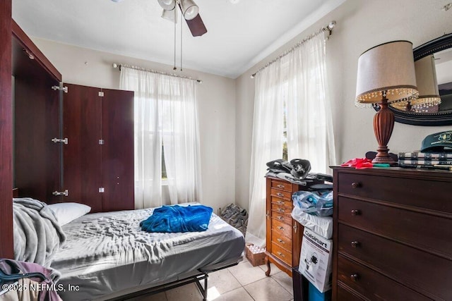 bedroom featuring light tile patterned floors and ceiling fan