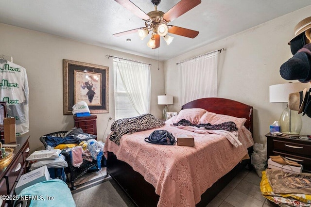 tiled bedroom with ceiling fan