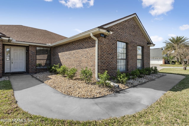 exterior space featuring brick siding