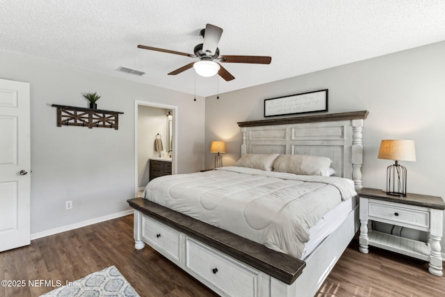 bedroom with dark wood-style floors, visible vents, a textured ceiling, and baseboards