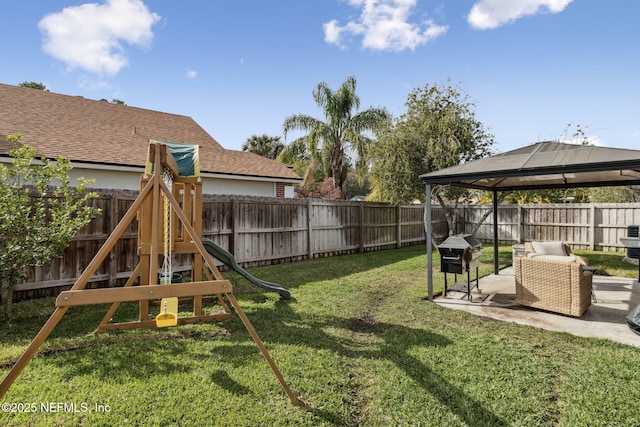 view of yard with a gazebo, a patio area, a fenced backyard, and a playground