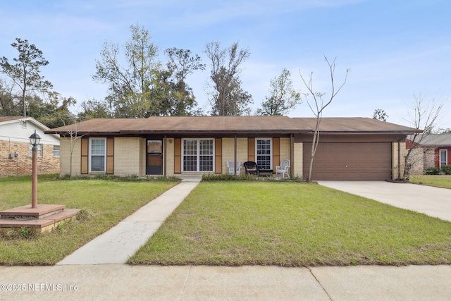 ranch-style home with a garage, a front yard, brick siding, and driveway