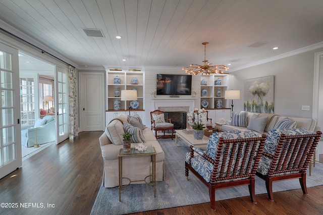 living room with visible vents, a notable chandelier, wood finished floors, wooden ceiling, and crown molding