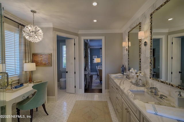 full bathroom featuring toilet, ornamental molding, a notable chandelier, and a sink