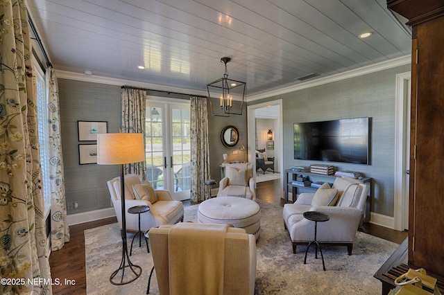 living area with wood finished floors, french doors, wallpapered walls, and ornamental molding