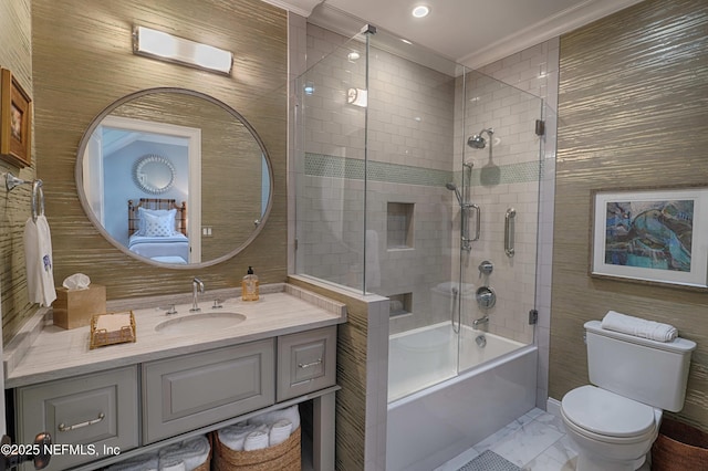 bathroom with toilet, ornamental molding, shower / bath combination with glass door, marble finish floor, and vanity