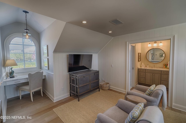 interior space featuring visible vents, recessed lighting, light wood-type flooring, and vaulted ceiling