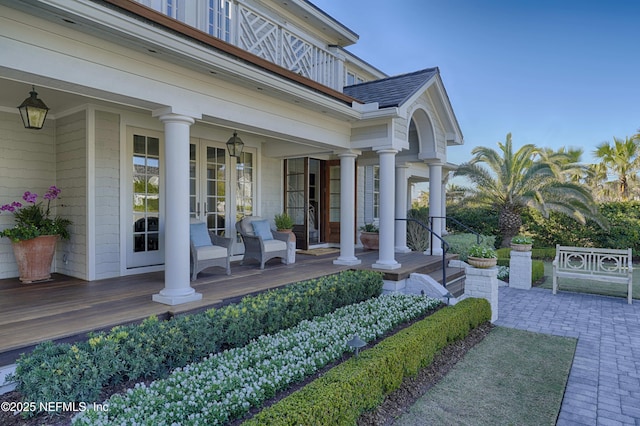 doorway to property featuring a porch and french doors