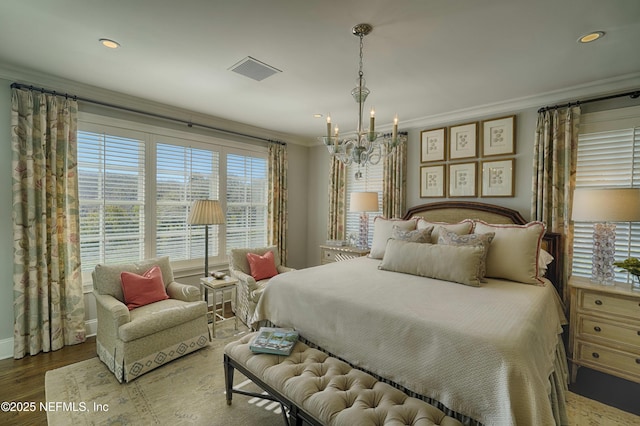 bedroom with visible vents, crown molding, recessed lighting, an inviting chandelier, and wood finished floors