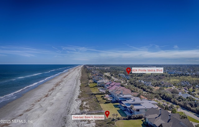 bird's eye view with a water view and a beach view