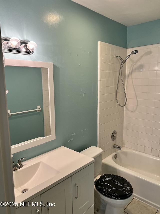 bathroom with washtub / shower combination, vanity, and toilet