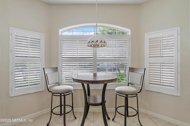 dining room with tile patterned flooring and baseboards