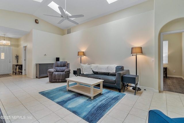 living area with a skylight, visible vents, ceiling fan, and light tile patterned floors