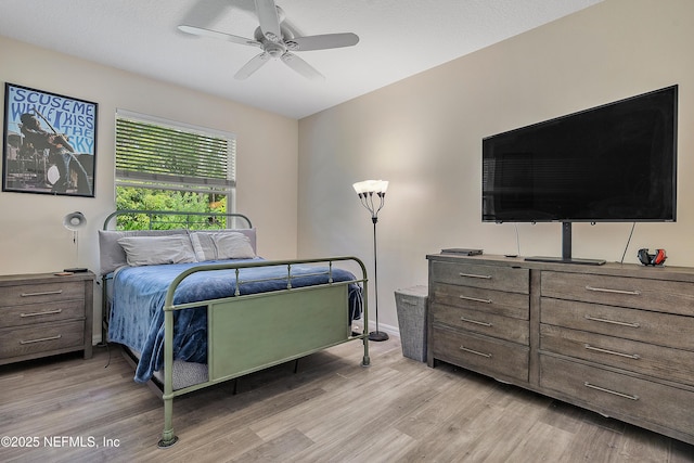 bedroom with ceiling fan and light wood-style floors