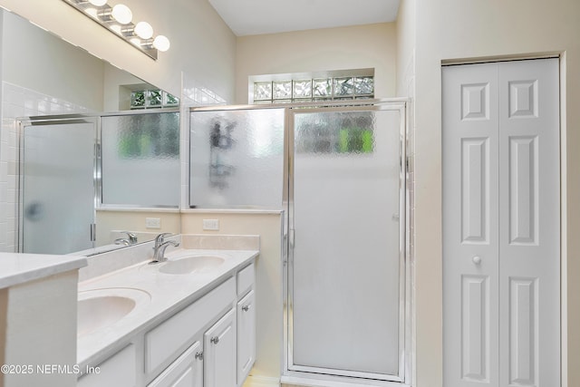 bathroom featuring a closet, a sink, and a stall shower