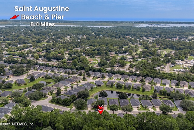 birds eye view of property with a water view and a residential view