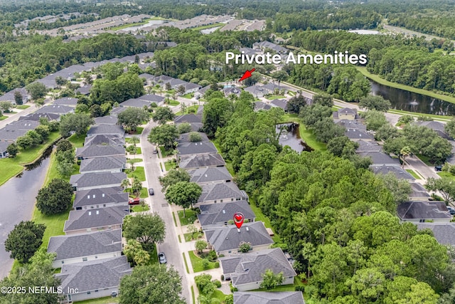 birds eye view of property with a water view and a residential view