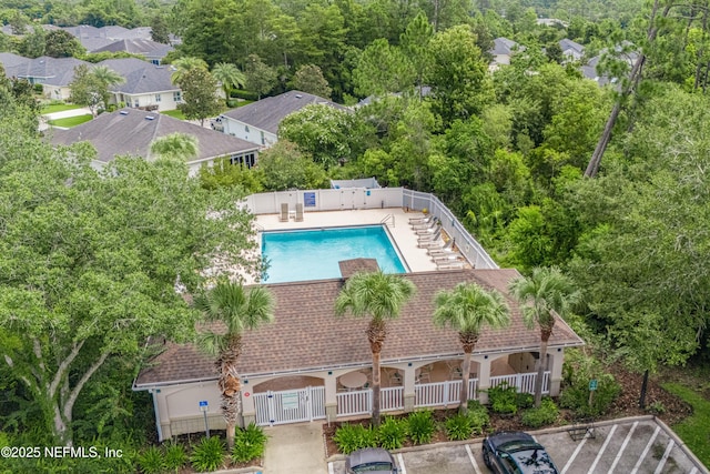 community pool featuring a patio area and fence private yard