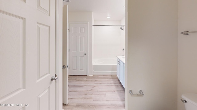 full bath featuring visible vents, vanity, toilet, and wood finished floors