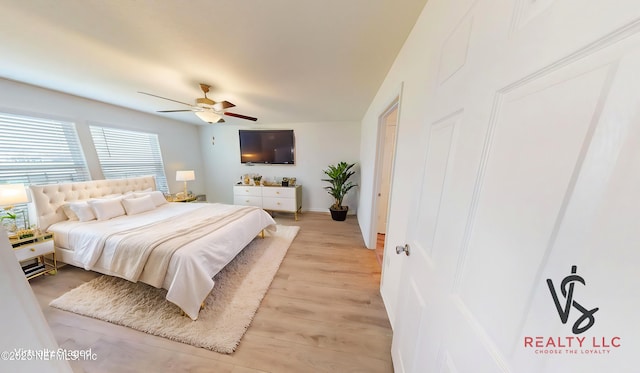 bedroom featuring light wood-style flooring and a ceiling fan