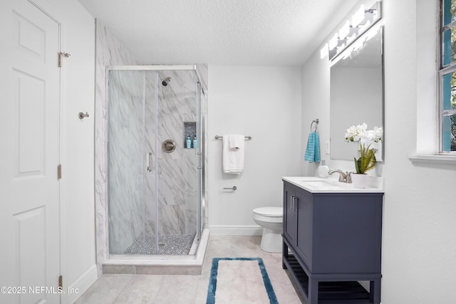 bathroom featuring a textured ceiling, toilet, vanity, baseboards, and a marble finish shower