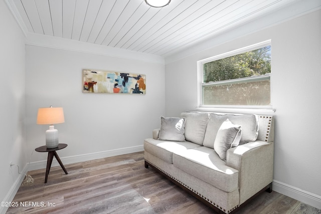 living area with wood ceiling, baseboards, and wood finished floors