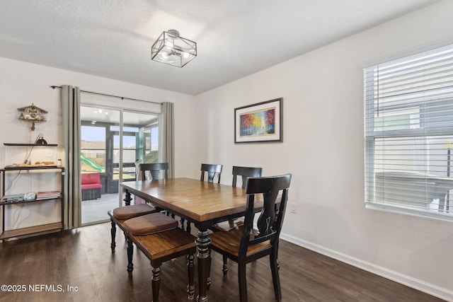 dining room featuring baseboards and dark wood-style flooring