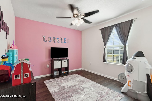 game room with ceiling fan, baseboards, and wood finished floors