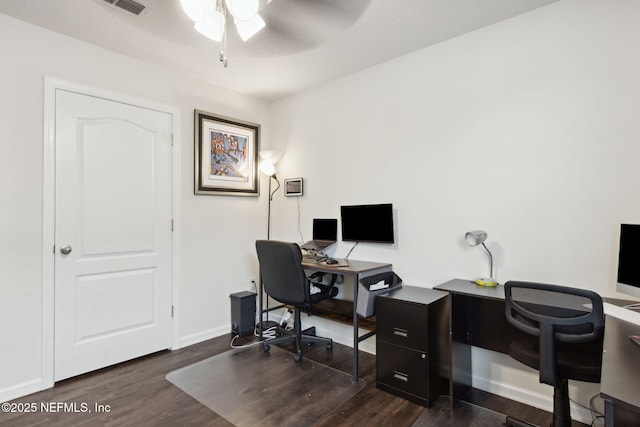 office featuring dark wood-type flooring, visible vents, ceiling fan, and baseboards