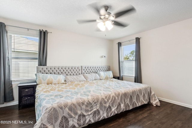 bedroom with a ceiling fan, dark wood finished floors, a textured ceiling, and baseboards