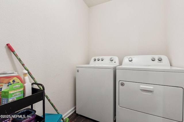 laundry room featuring dark wood-type flooring, laundry area, washer and clothes dryer, and baseboards