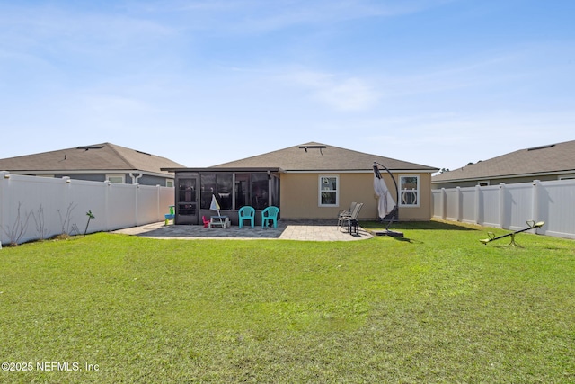 rear view of property with a sunroom, a fenced backyard, a patio area, and a yard